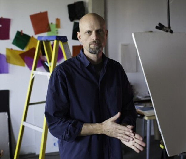 Photo of Brent Wahl with ladders and color block wall art behind him